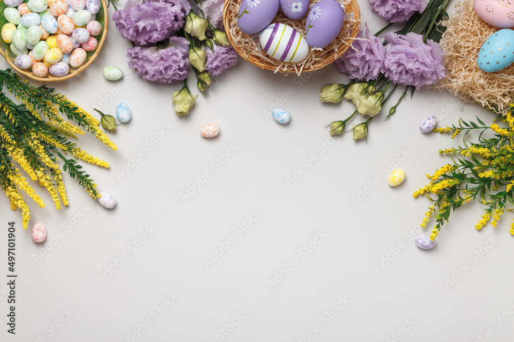 Easter concept. Flowers and blooming yellow sprigs of eggs in a basket on a gray background. Easter concept. Flowers and blooming yellow sprigs of eggs in a basket on a gray background.