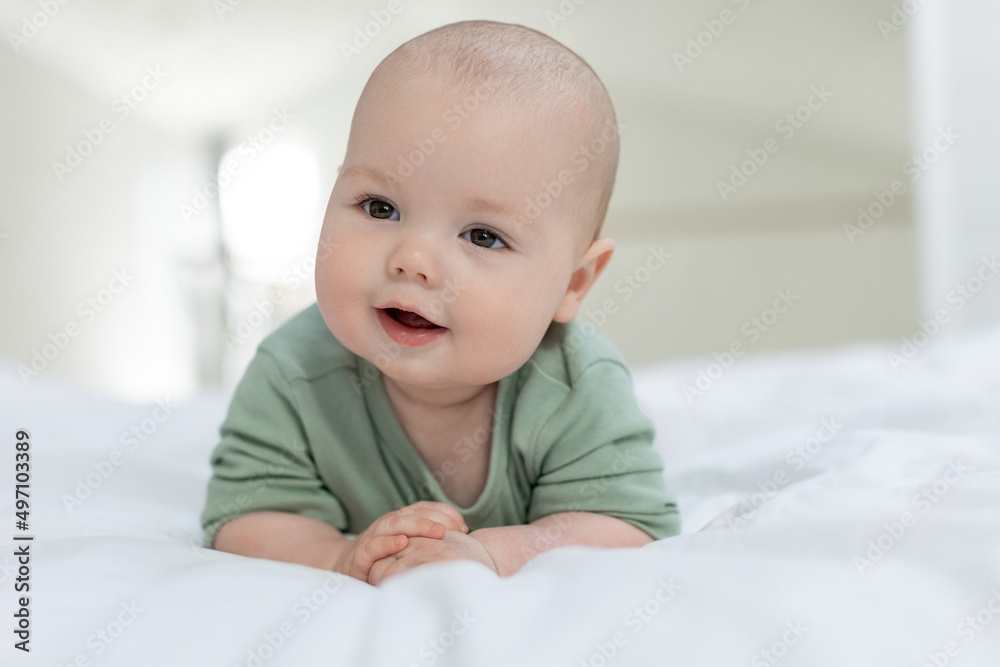 The baby lies on the bed. Little baby. High quality photo The baby lies on the bed. Little baby. High quality photo