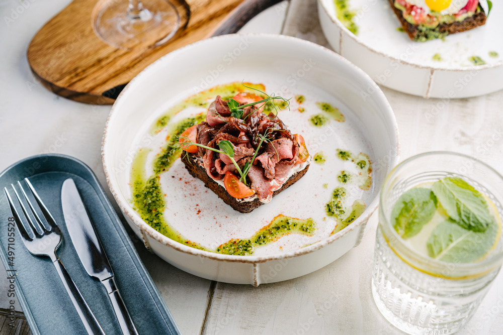 Smorrebrod, Danish open sandwich with roast beef, sweet onion and cherry tomato