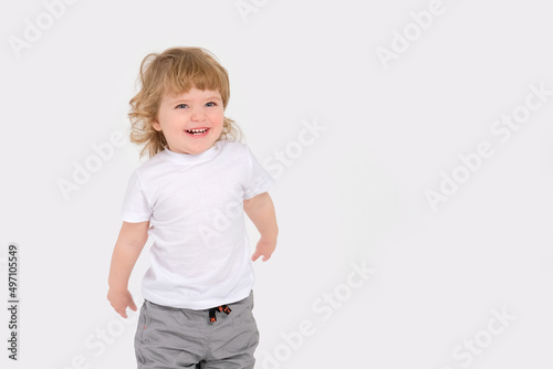 Cheerful beautiful baby on a white background. Copy space . High quality photo