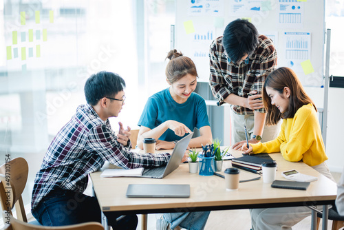 Young colleagues having great business conversations in a modern coworking office. Teamwork concept. Horizontal blurry background. Fireworks.