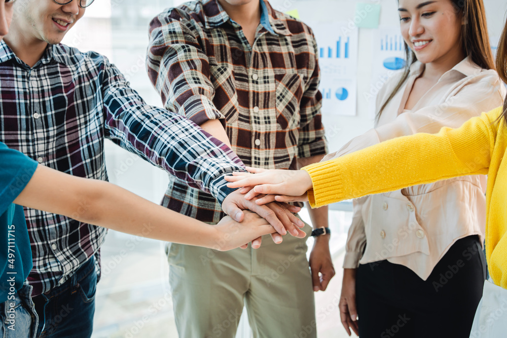 young business people putting their hands together. Stack of hands. Unity and teamwork concept. young business people putting their hands together. Stack of hands. Unity and teamwork concept.