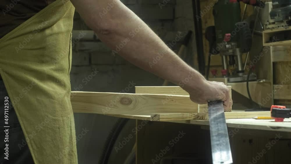 Action. A professional carpenter is working on a project in his workshop. Industrial woodworking machine. Action. A professional carpenter is working on a project in his workshop. Industrial woodworking machine.
