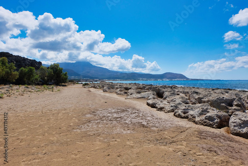 Rocky beach on Crete with mountainside