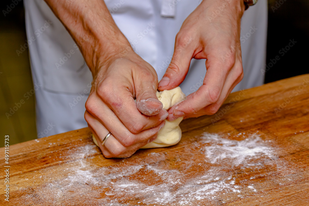 The cook prepares dough from flour and eggs