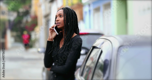 Teen girl talking on phone outside in street, adolescent teenager woman speaking on cellphone