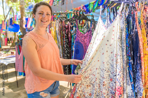 woman with colorful clothes outdoors at typical traditional market shopping photo