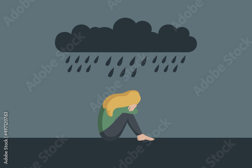 lonely depressed girl sitting alone in the rain