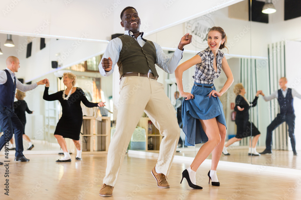 Fototapeta premium Woman with african man practising charleston dancing