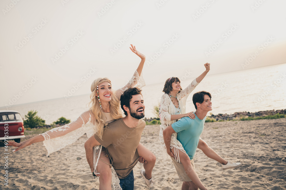 Photo of young impressed two girlfriend boyfriend piggyback go on shore sand exotic holiday trip wear trend cloth outdoors
