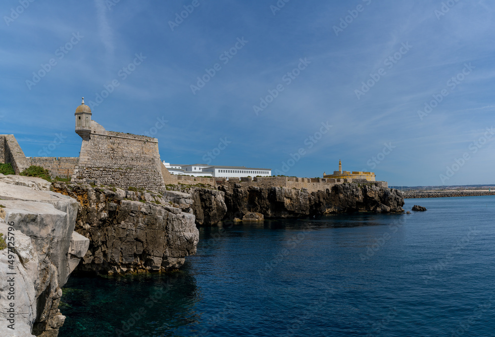 view of the jagged rocky coast and historic fortress in the center of Peniche