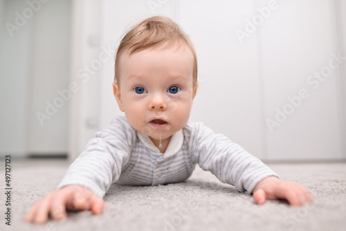 Baby boy smiling. Drooling in a child. Infant baby boy drooling close-up. Cute little baby looks into the camera and drooling. Creative concept photos photo
