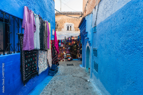 Morocco, Chefchaouen, Cobblestone alley and souvenirs for sale © Image Source