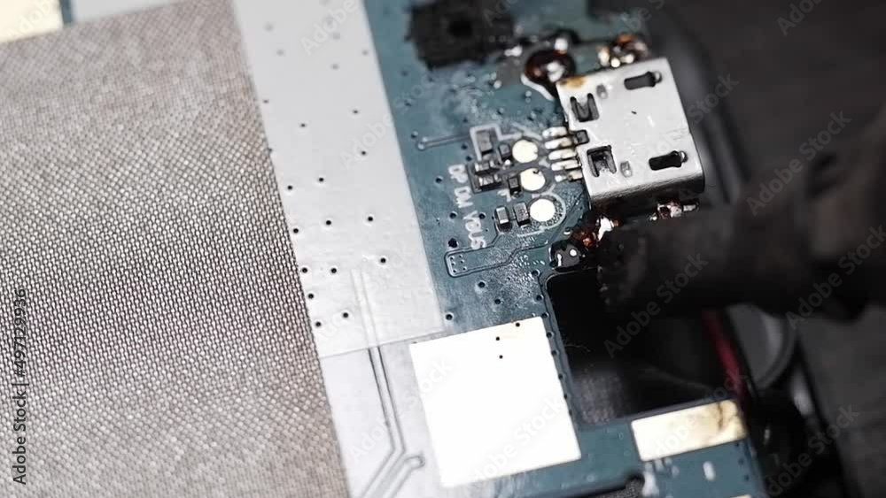 Repair of the printed circuit board by soldering closeup. Soldering