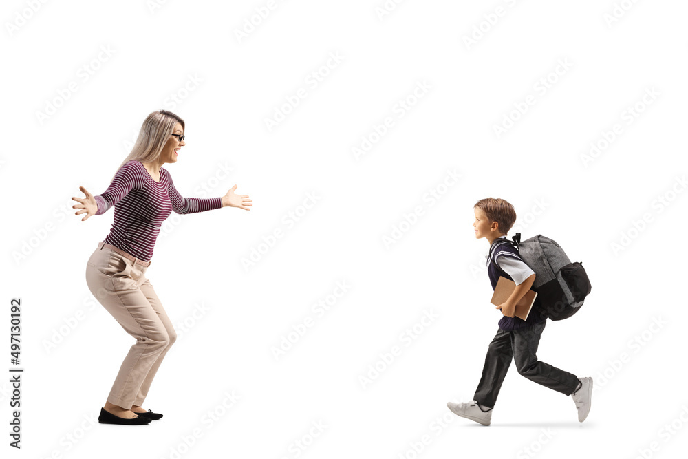 Full length profile shot of a schoolboy rinning towards mother for a hug