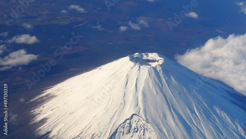 Top of Mt. Fuji.  Bird eyes view of big and high mountain Fuji of Japan. Mount Fuji Yama from sky above. Aerial view. With white snow on top and clouds around. Represent winter season of Japan.