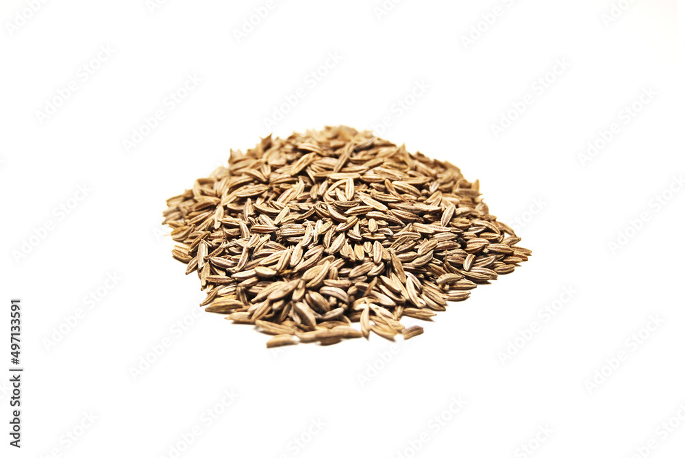 A pile of whole cumin seeds isolated on white background A pile of whole cumin seeds isolated on white background