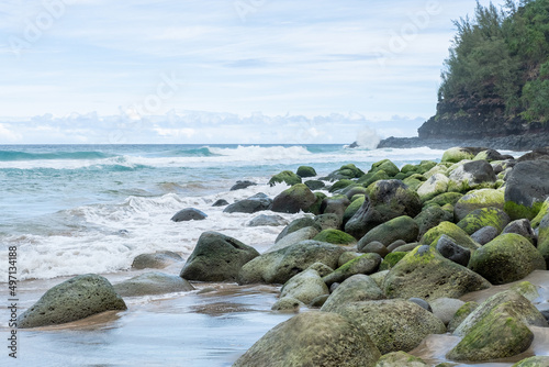 Round greed boulders on a tropical coastline