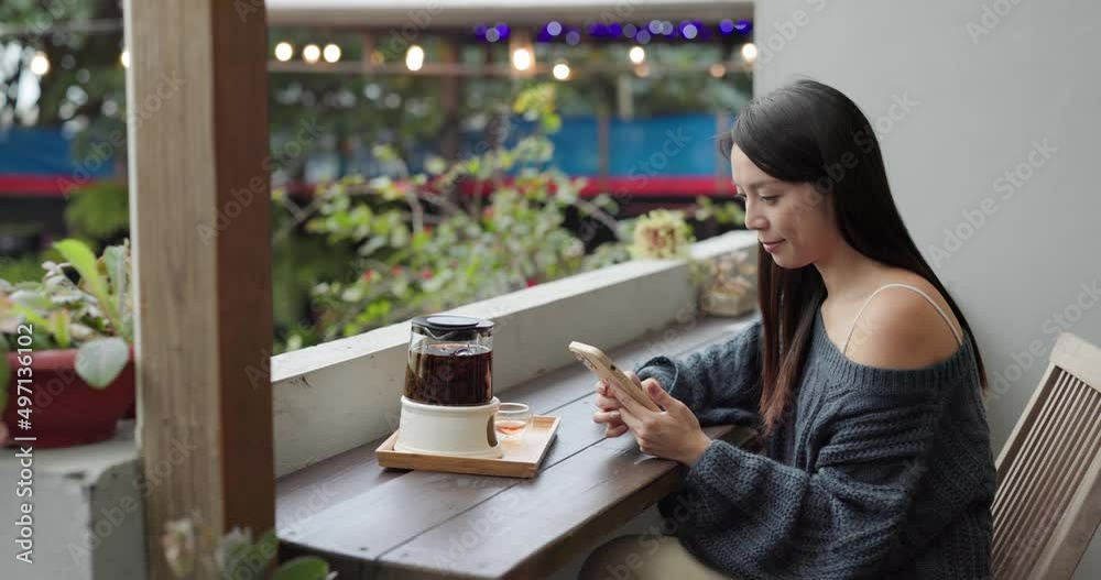 Woman browse on mobile phone at outdoor cafe Woman browse on mobile phone at outdoor cafe