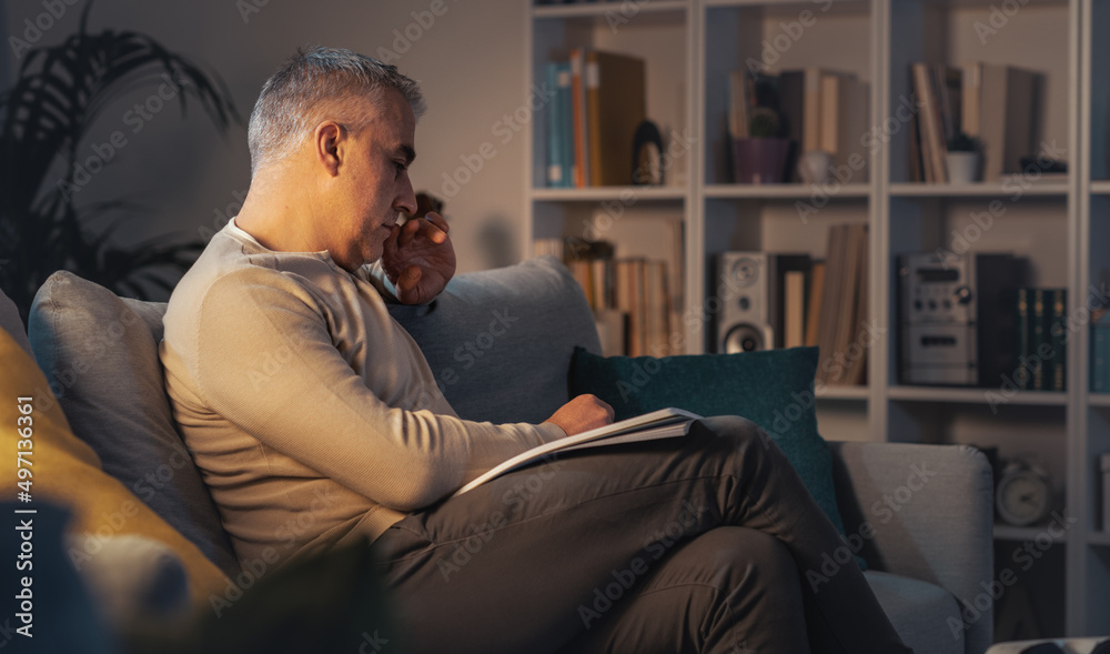 Man relaxing on the couch and reading
