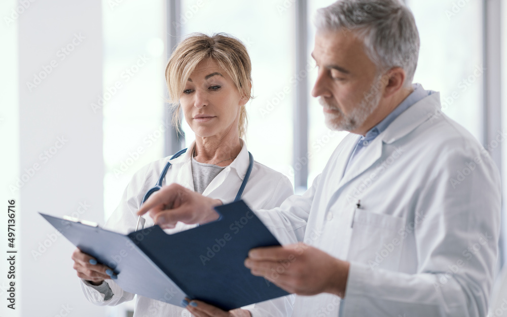 Doctors checking medical records in the office Doctors checking medical records in the office
