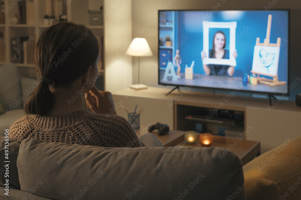 Woman watching a painting and art course online Woman watching a painting and art course online