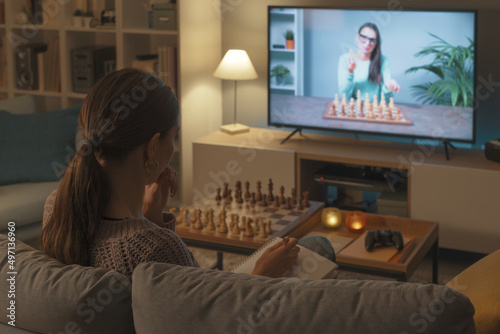 Woman learning chess on TV