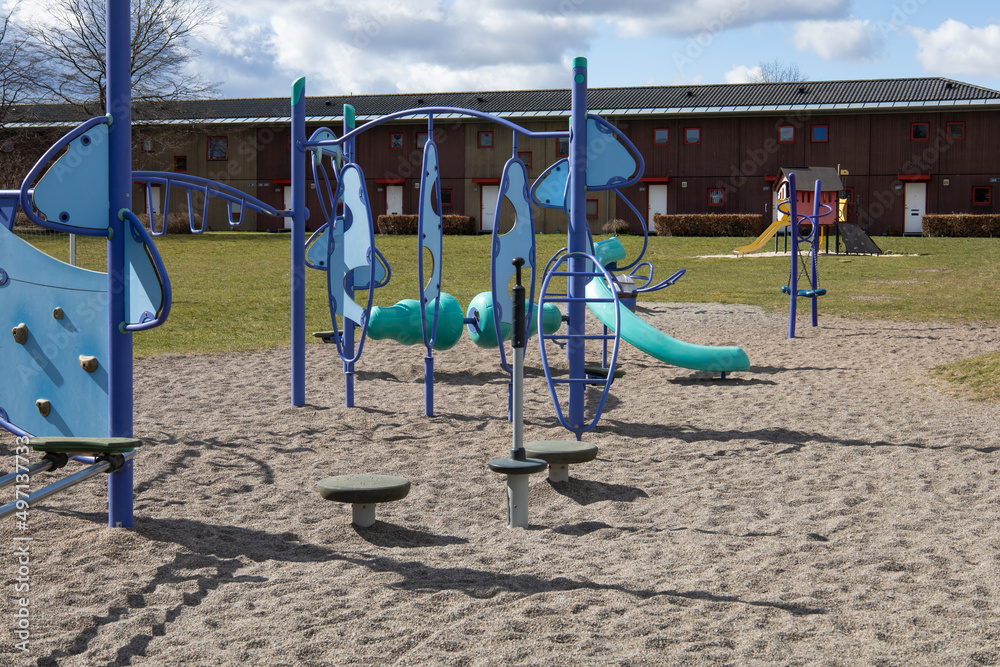 Children playground next to residential buildings on a sunny day. High quality photo