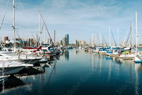 Shoreline Village in Rainbow Harbor In Long Beach, California. Shops line the edge of the marina area, and boats are docked in it's harbor. © Curioso.Photography
