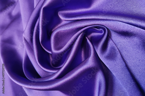 Purple crumpled or wavy fabric texture background. Abstract linen cloth soft waves. Silk atlas or stretch jacquard. Smooth elegant luxury cloth texture. Concept for banner or advertisement.