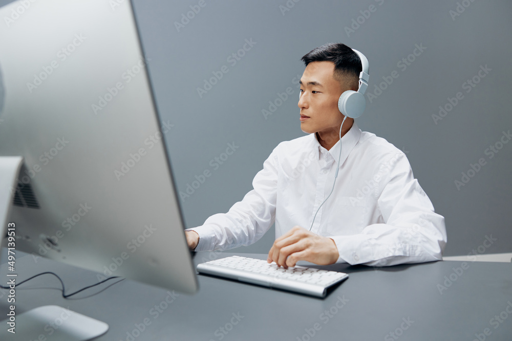 worker in front of the computer with headphones emotions Lifestyle work worker in front of the computer with headphones emotions Lifestyle work