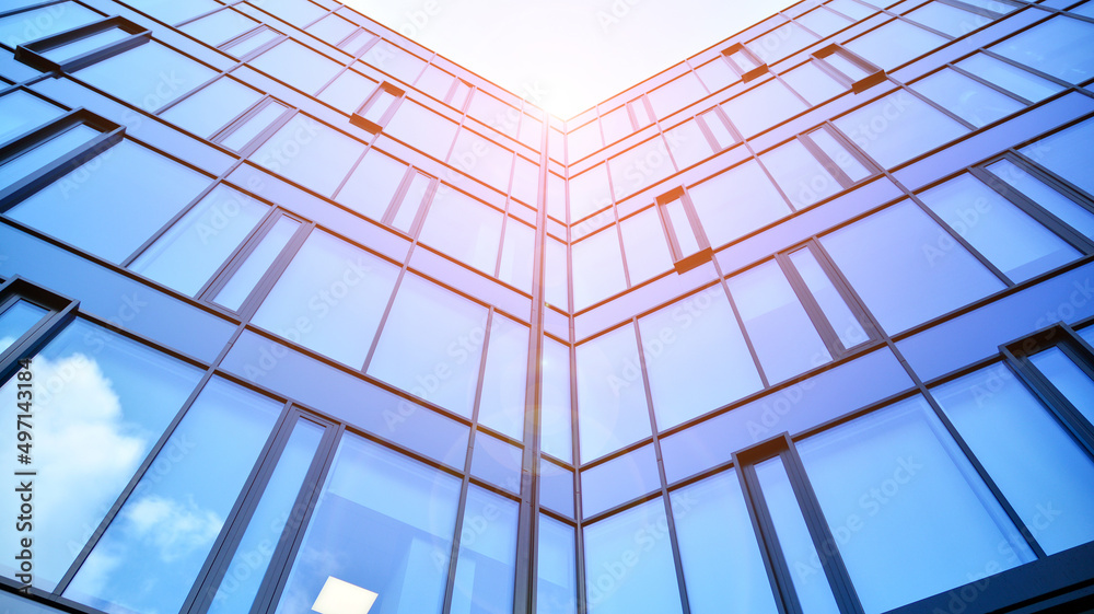 Modern office building with glass facade on a clear sky background. Abstract close up of the glass-clad facade of a modern building covered in reflective plate glass. Modern office building with glass facade on a clear sky background. Abstract close up of the glass-clad facade of a modern building covered in reflective plate glass.