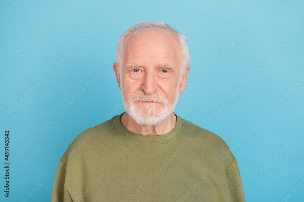 Portrait of attractive content grey-haired man wearing cozy pullover isolated over vibrant blue color background Portrait of attractive content grey-haired man wearing cozy pullover isolated over vibrant blue color background