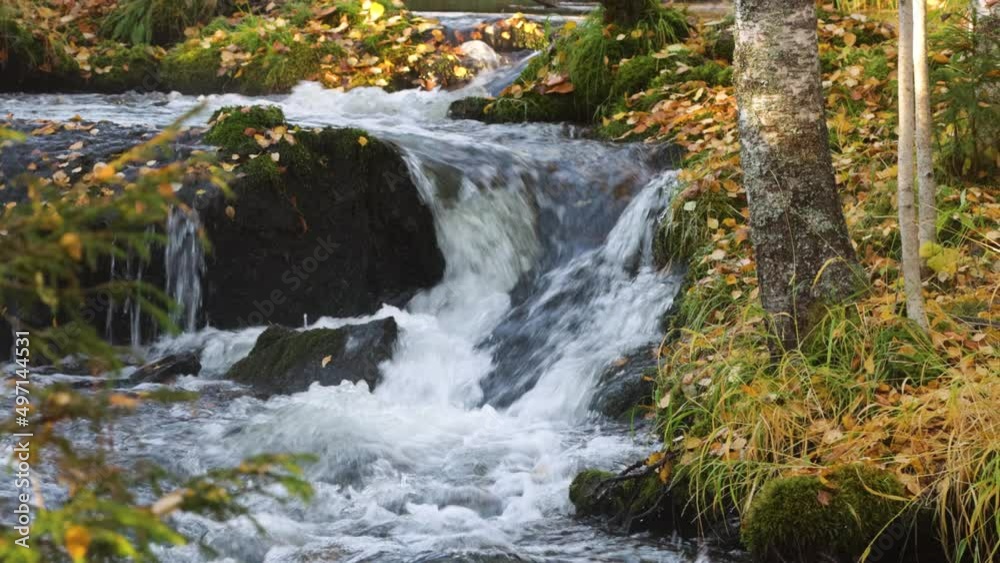Small waterfall during autumn morning near Kuusamo, Northern Finland Small waterfall during autumn morning near Kuusamo, Northern Finland