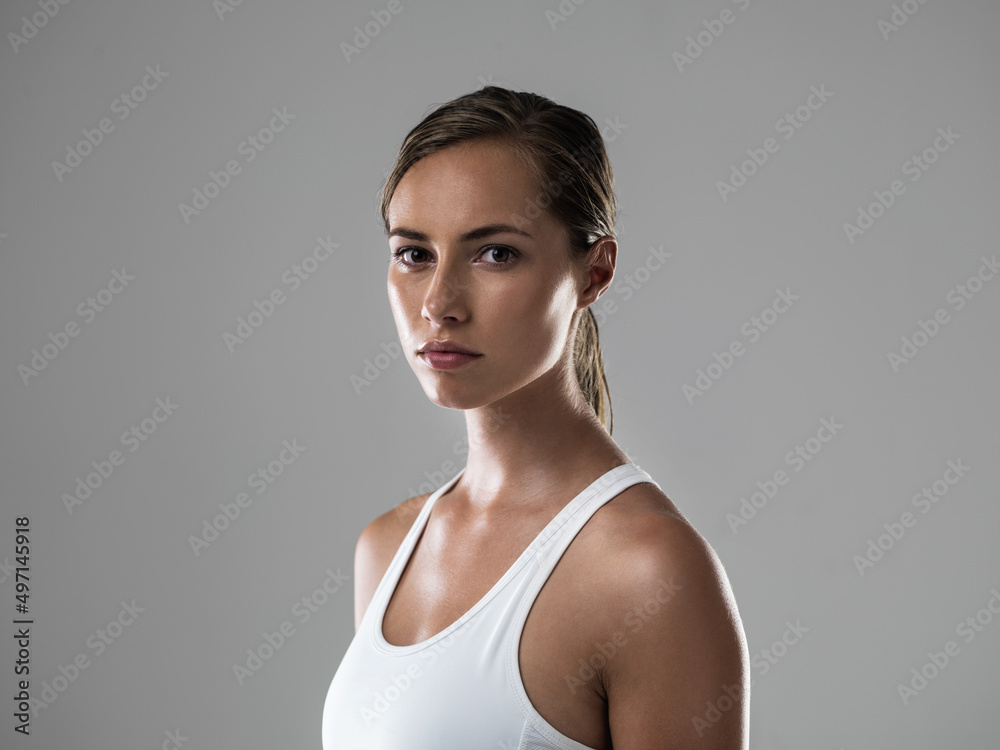 Serious about getting fit. Cropped shot of an attractive brunette looking confident about her upcoming workout. Serious about getting fit. Cropped shot of an attractive brunette looking confident about her upcoming workout.