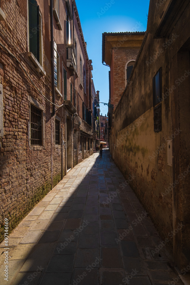 VENICE, ITALY - August 27, 2021: View of narrow and historic alley in the center of Venice