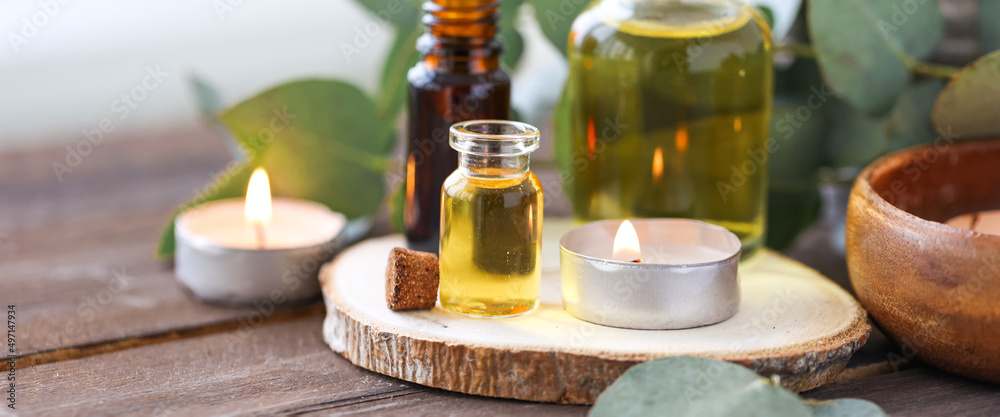 Assortment of natural oils in glass bottles on wooden background. Concept of pure organic ingredients in cosmetology. Bath accessories, atmosphere of harmony, relax. Banner. Healthy lifestyle