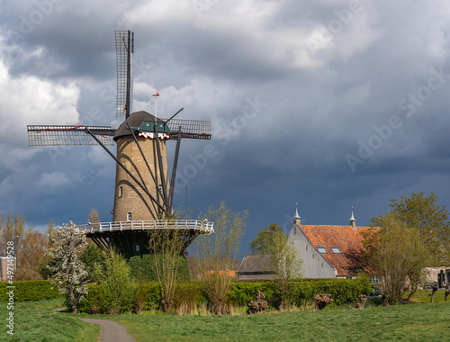 Typical dutch rural scenery with traditional windmill in the village of Terheijden, Province North Brabant photo