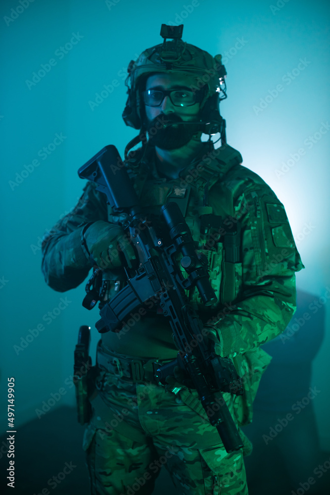 Portrait of handsome man in military uniform. Bearded man in army ammunition holding machine gun. Portrait, army, weapon airsoft concept Portrait of handsome man in military uniform. Bearded man in army ammunition holding machine gun. Portrait, army, weapon airsoft concept