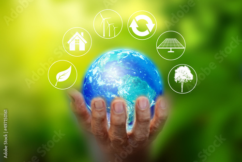 Human Hand holding Earth ball on green bokeh background. Concept of World Environment Day, Save the Earth, Preserve Nature, energy in nature. Elements of this image furnished by NASA.