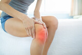 Woman messaging sprained sore knee 