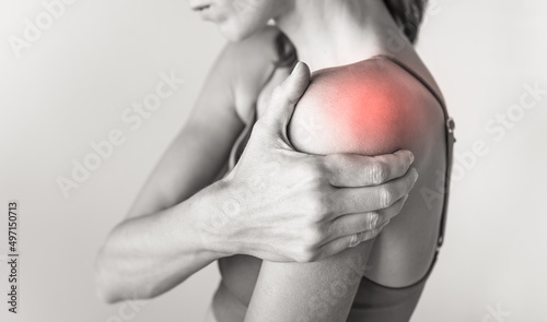 woman with pain in their shoulder joint photo