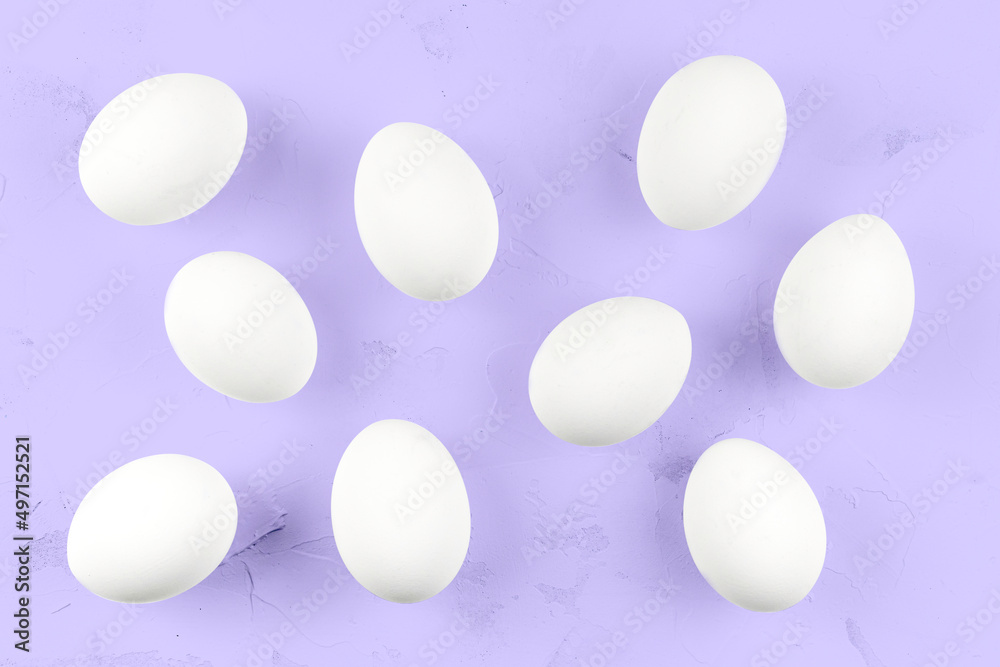 White eggs on a purple textured background.