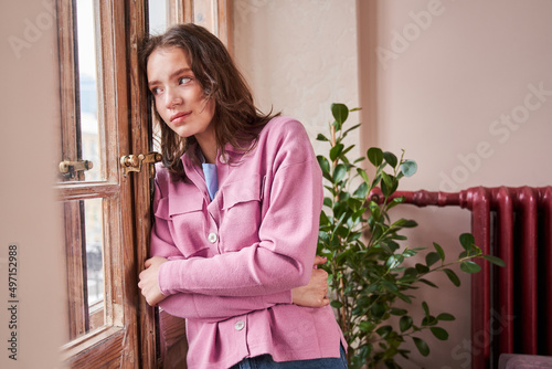 Quadro em tela Girl relaxing at psychology consulting room, she is looking at the window and cr