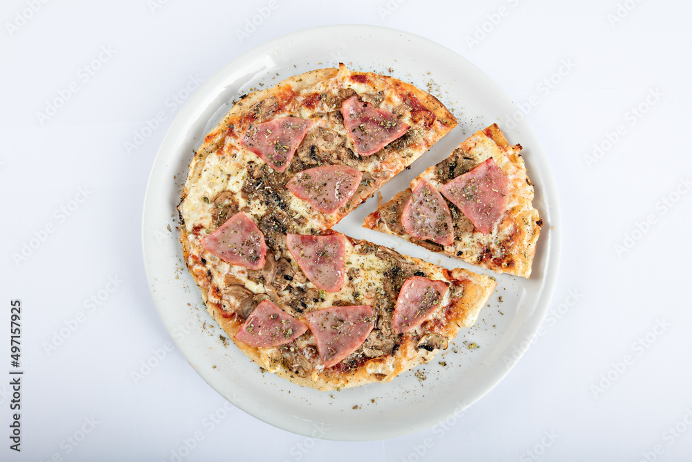 mixed pizza with pieces of ham on the table mixed pizza with pieces of ham on the table