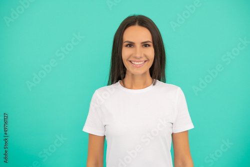 happy young woman in white shirt on blue background