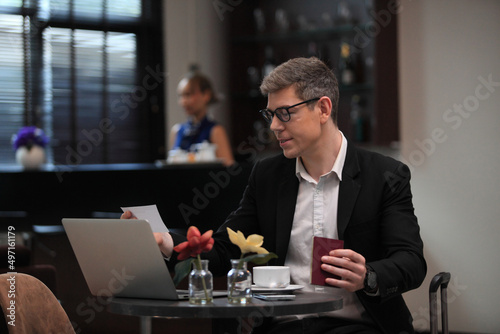 businessman checking a travelling passport. passengers in lounge  International airports. exclusive room photo