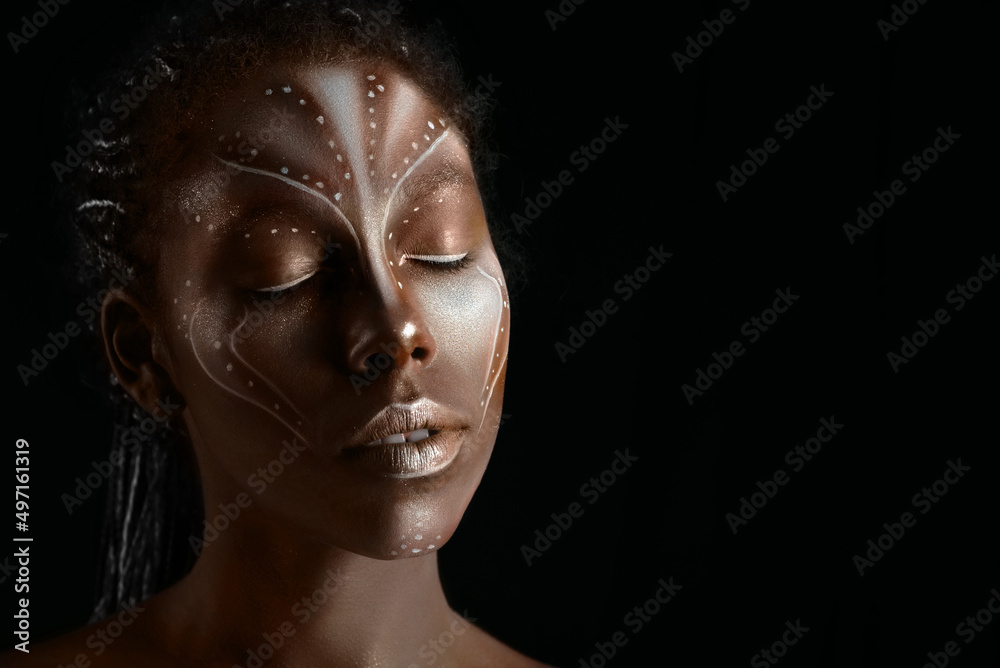 Art photo of Africal woman with tribal ethnic paintings on her face Art photo of Africal woman with tribal ethnic paintings on her face