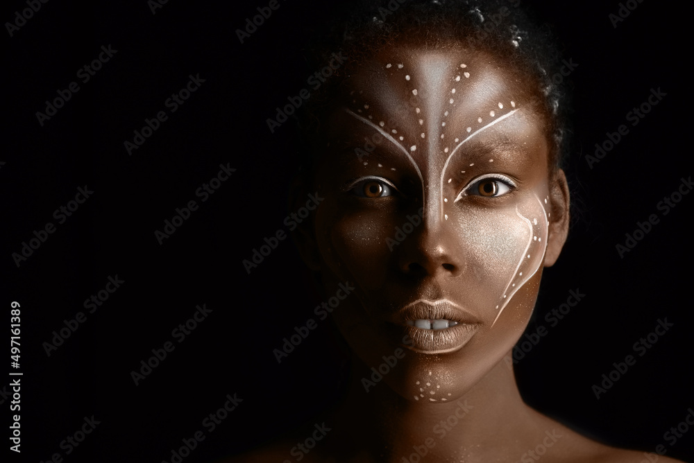 Art photo of Africal woman with tribal ethnic paintings on her face Art photo of Africal woman with tribal ethnic paintings on her face
