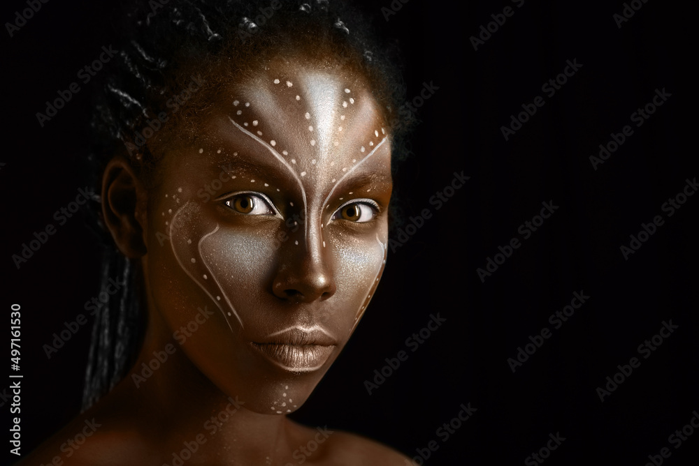 Art photo of Africal woman with tribal ethnic paintings on her face